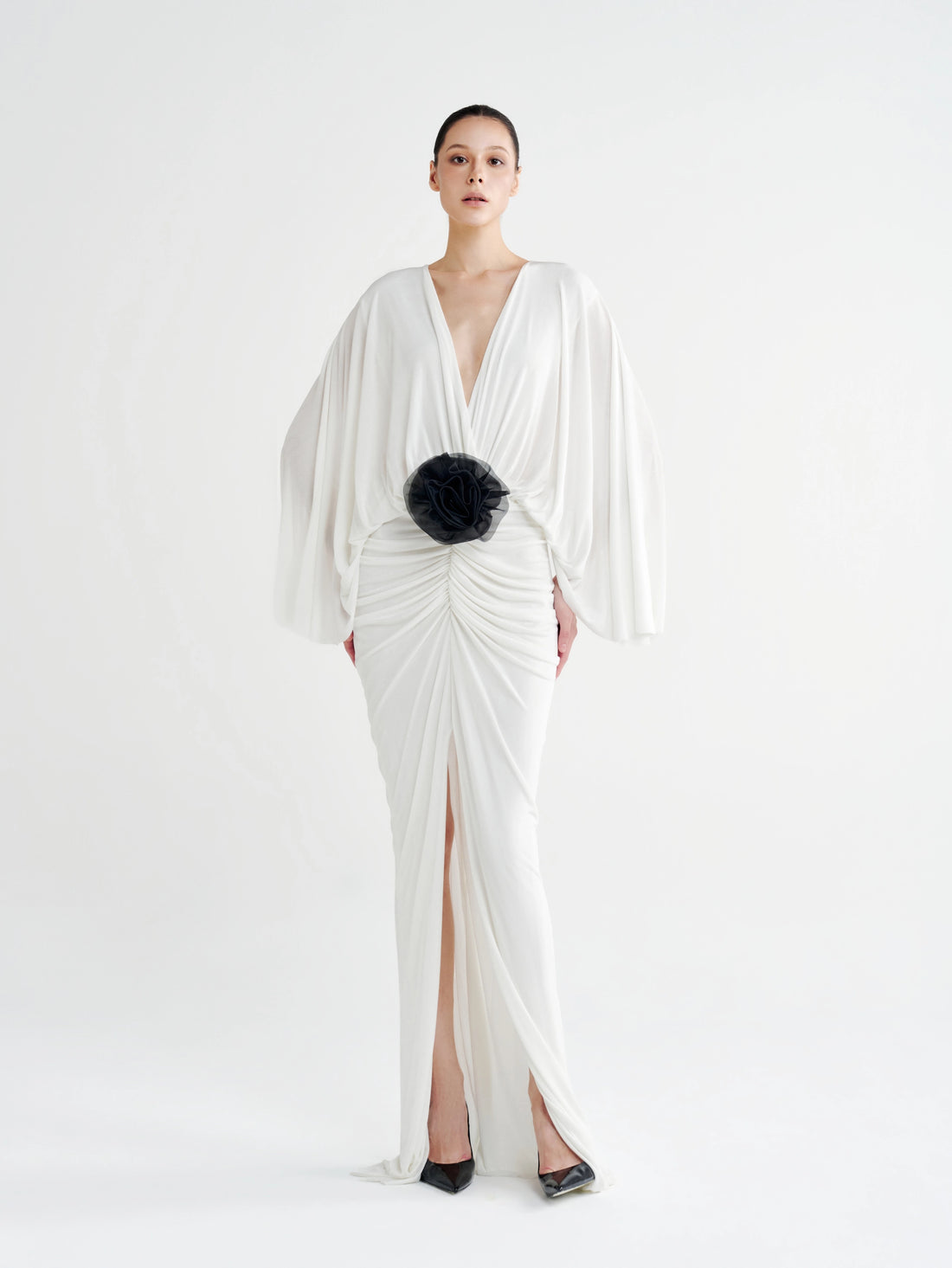 White Rosette Plunging Batwing Ruched Dress with a black rosette at the waist, front view