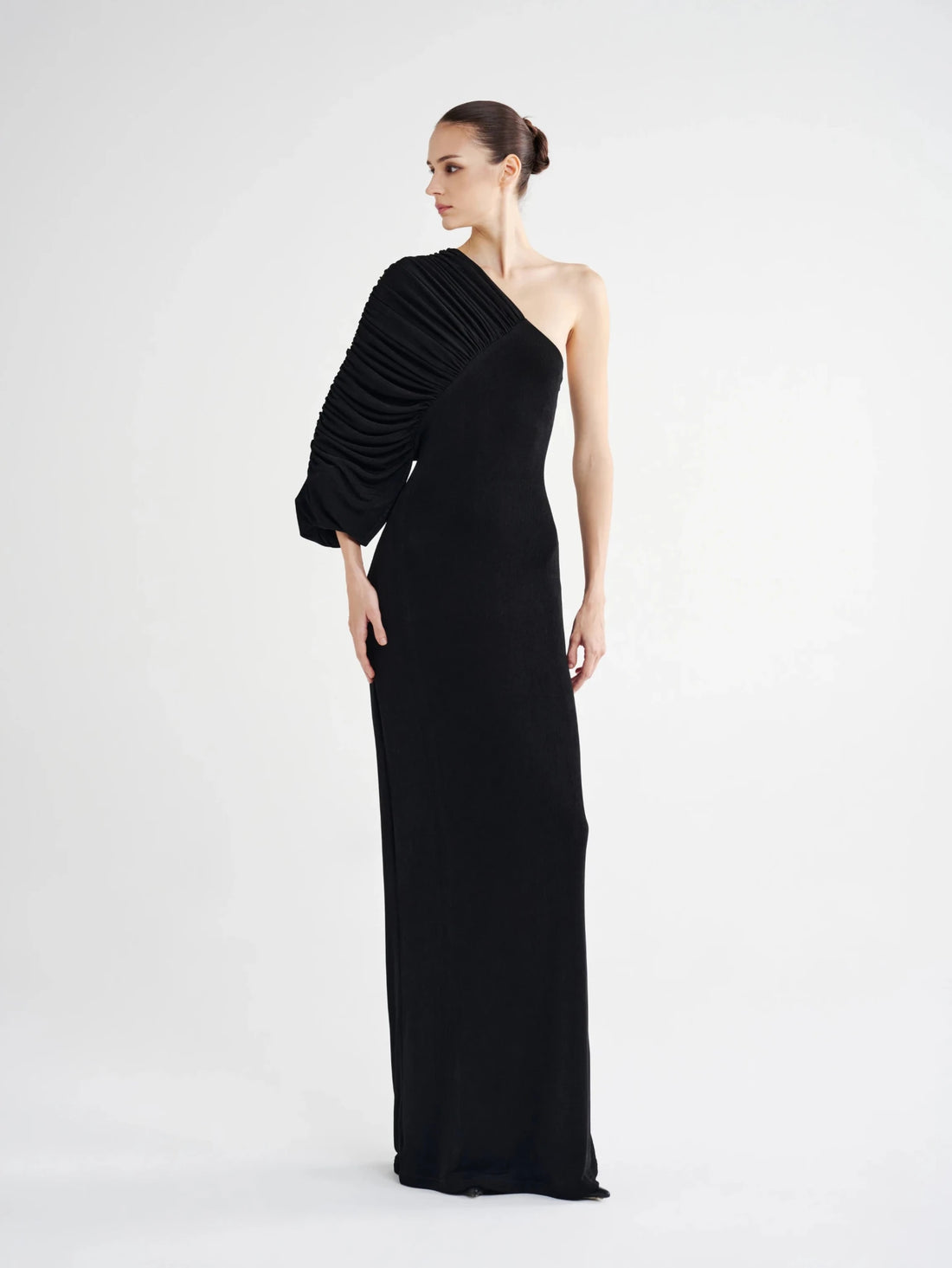 Black Pleated Single-Sleeve Column Dress, front view of the fan-pleated sleeve and floor-length column skirt