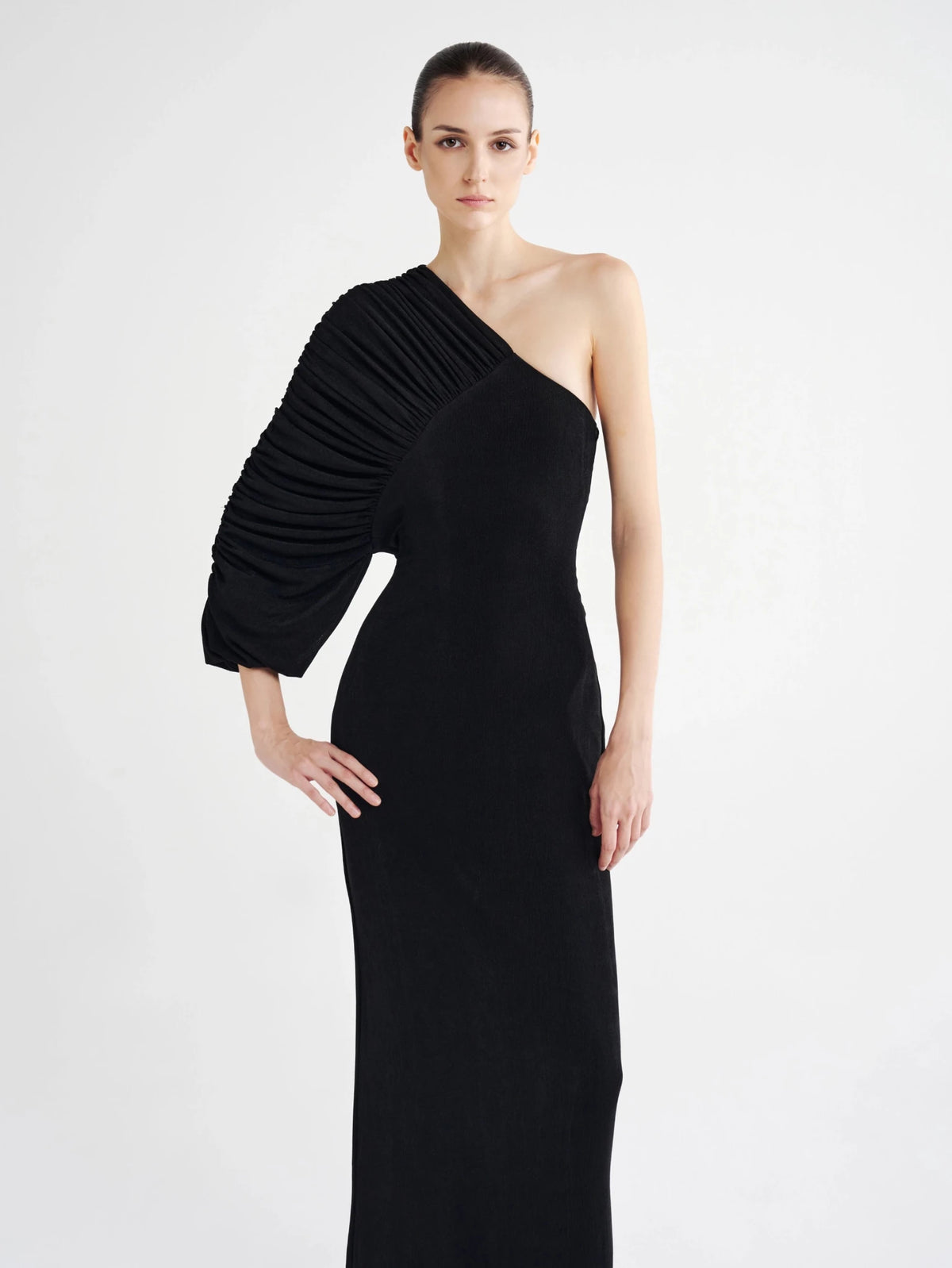Black Pleated Single-Sleeve Column Dress, close-up of the pleated statement sleeve and bare shoulder